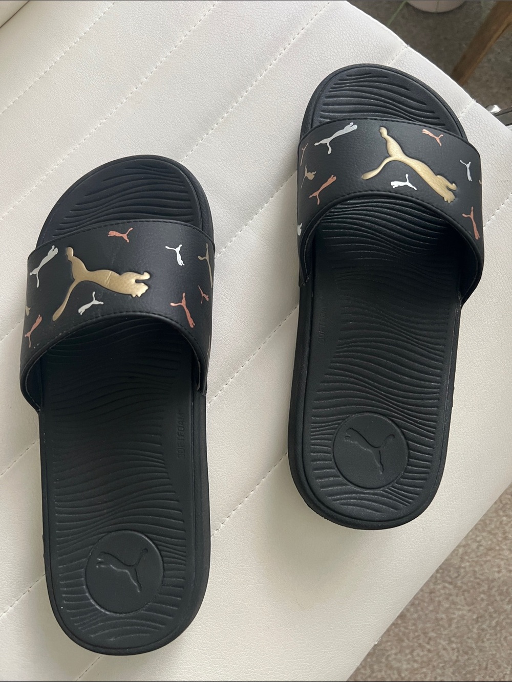 Puma Black Slides with Gold and Rose Gold Logo Accents